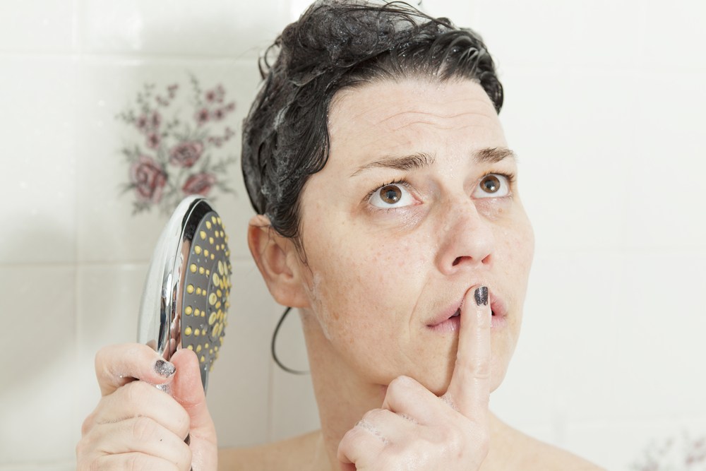 Woman thinking in shower Gary Dumais